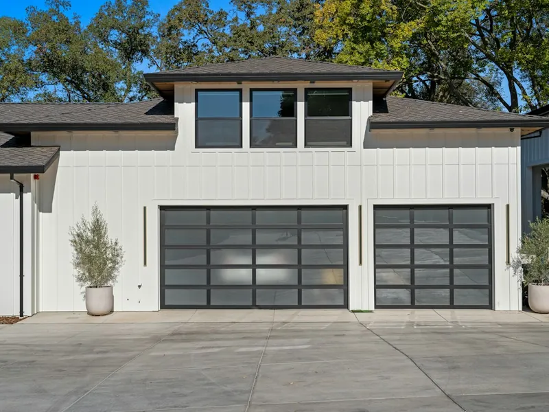 White home with two aluminum and glass garage doors in El Cajon